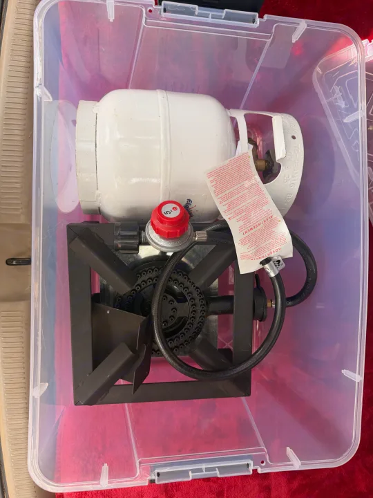 Portable propane stove & tank for RV rental camping. Essential outdoor cooking gear, packed in a clear storage bin.. Toyota Sienna 2002