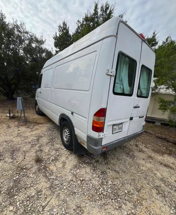 This white Sprinter rv rental is ready for your next travel adventure, parked at a cozy campsite.. Dodge Sprinter Van 2006