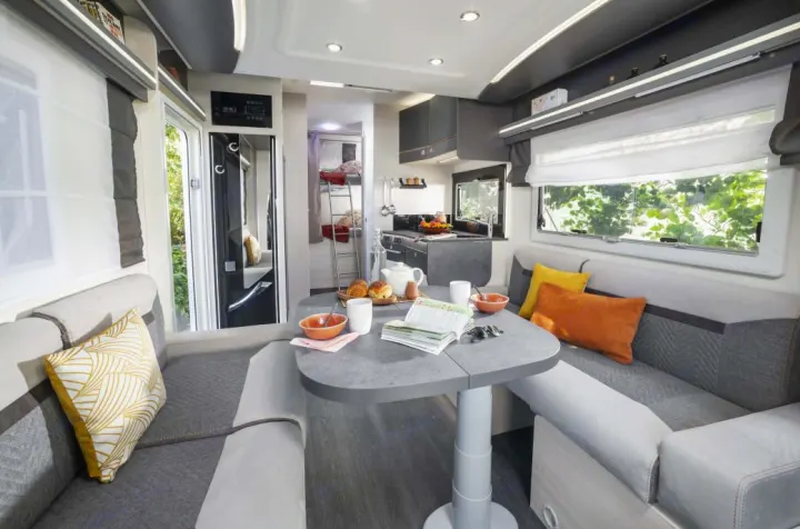 Cozy RV rental interior with dining area, kitchen, and bunk beds, set up for a comfortable family adventure.. Chausson 720 VIP Titanium 2021