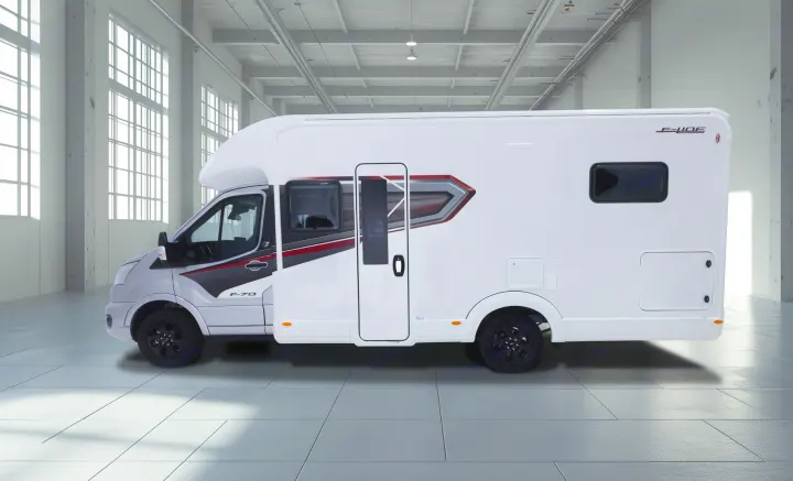 Side view of a white F-70 motorhome, ideal for rv rental, with black wheels, parked in a spacious, sunlit warehouse.. Auto-Trail F70 2025
