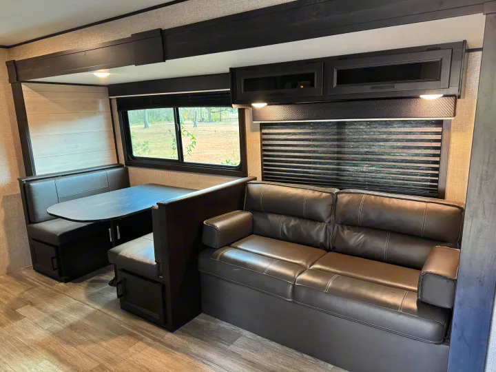 Spacious and modern RV rental interior featuring a comfortable dinette, plush sofa, and ample storage for your travels.. Jayco Jay Flight 2022