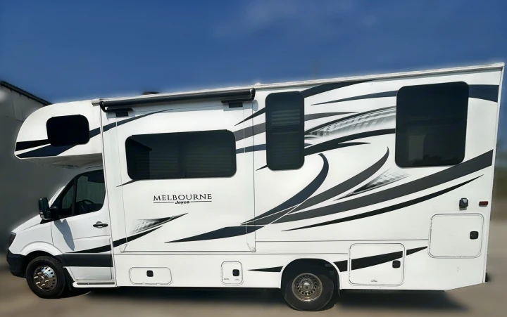 Side view of a white Melbourne Jayco Class C motorhome, featuring sleek black graphics. Ideal for your next rv rental adventure.. Jayco Melbourne 2019
