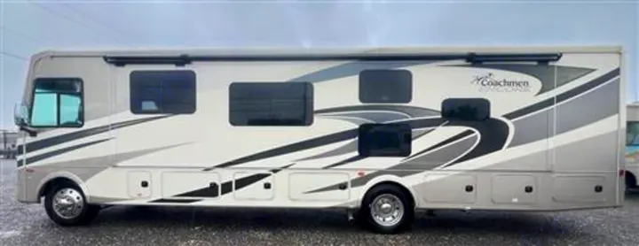 A spacious Coachmen Encore RV for rental, showcasing its beige and gray exterior with distinct graphics and multiple windows.. Coachmen Encore 2021