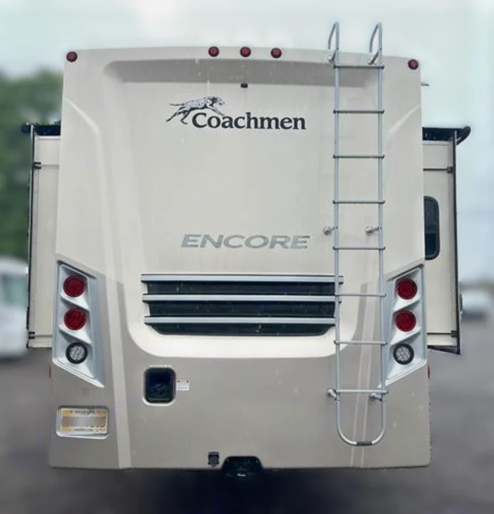 Rear of a Coachmen Encore RV rental. This motorhome features a ladder, taillights, and tow hitch, ready for adventure.. Coachmen Encore 2021