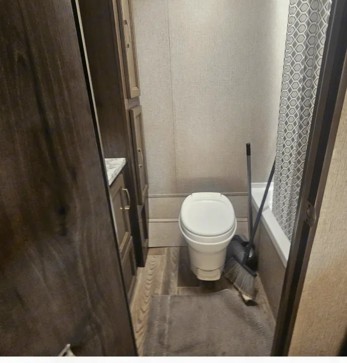 Compact RV rental bathroom with toilet, shower, and vanity. Functional small space for travel.. jayco Jay Flight 2020