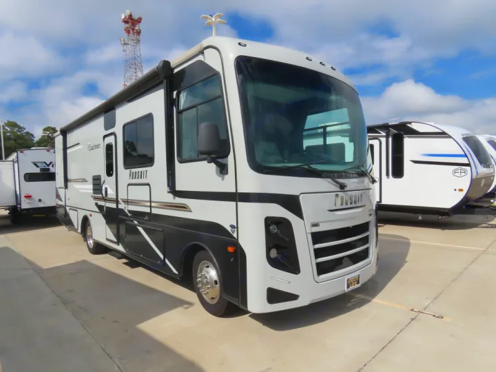 A sleek white and black Coachmen Pursuit motorhome, ideal for rv rental. Parked outdoors under a blue sky, ready for adventure.. Coachmen PURSUIT 31BH 2023