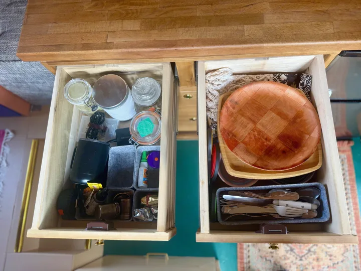 Organized RV rental drawers with kitchenware, utensils, jars, and utility items. Perfect for compact living on the road.. Ford Transit 2019