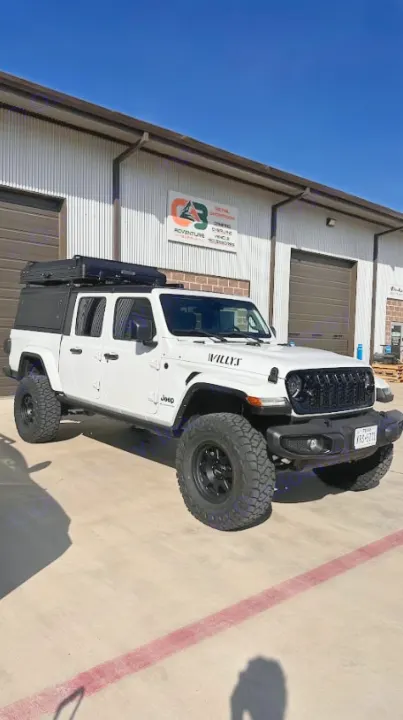 White Willys Jeep Gladiator with a rooftop tent, customized for overlanding adventures. Perfect for your next RV rental.. Jeep Gladiator Willys 2024