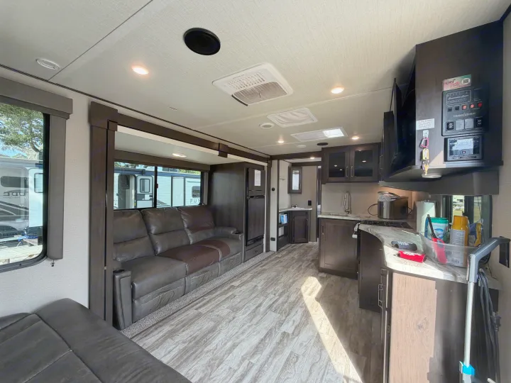 Spacious RV rental interior with a comfortable living area, fully equipped kitchen, and modern design.. Grand Design Transcend 265BH 2022
