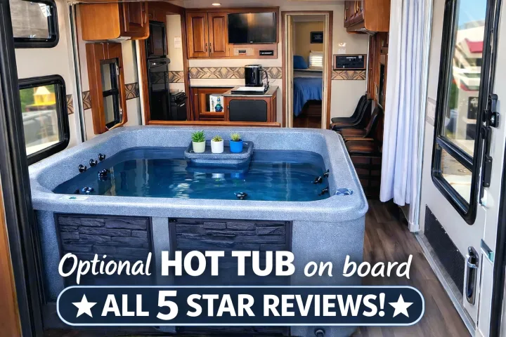 Luxurious RV rental interior features a prominent hot tub, blue water visible. Beyond, a kitchen & bedroom. Unique glamping amenities!. Keystone RV Raptor Toy Hauler 2012