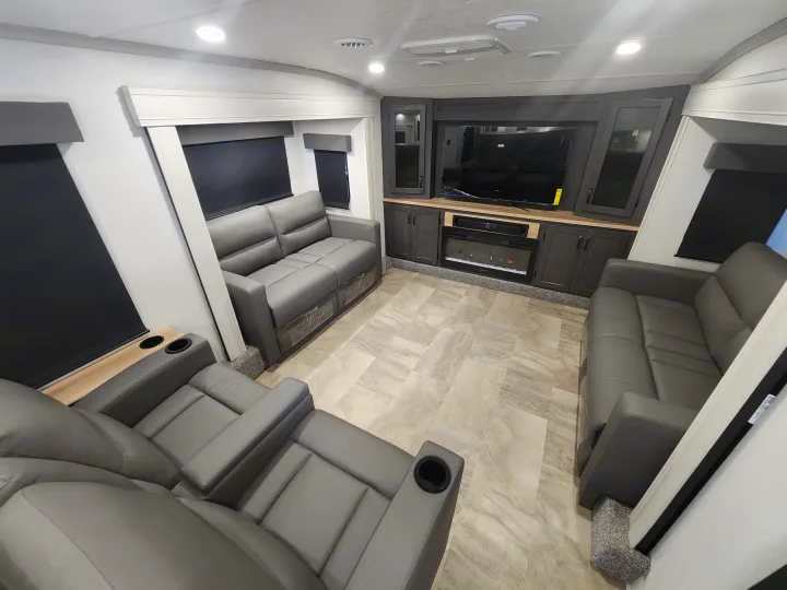 RV rental: Sleek living room features gray recliners, entertainment center with a large TV, and electric fireplace.. phoenix 334FL 2026