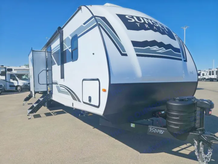 Sunset Trail travel trailer rv rental. White, with mountain graphics & extended steps, ready for your camping adventure.. Crossroads RV Sunset Trail Super Lite 2025
