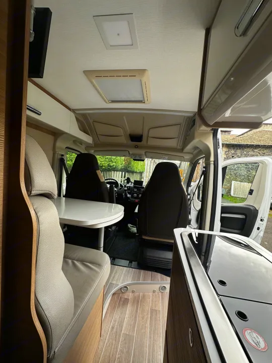 Modern rv rental campervan interior, showing kitchen, seating, and front cab. Ready for your next adventure.. mc louis menfys 2023