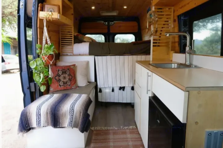 Discover this charming rv rental: a cozy van conversion with a kitchen, bed, and inviting seating, ideal for mobile living and tiny home adventures.. Dodge Ram 1500 2021