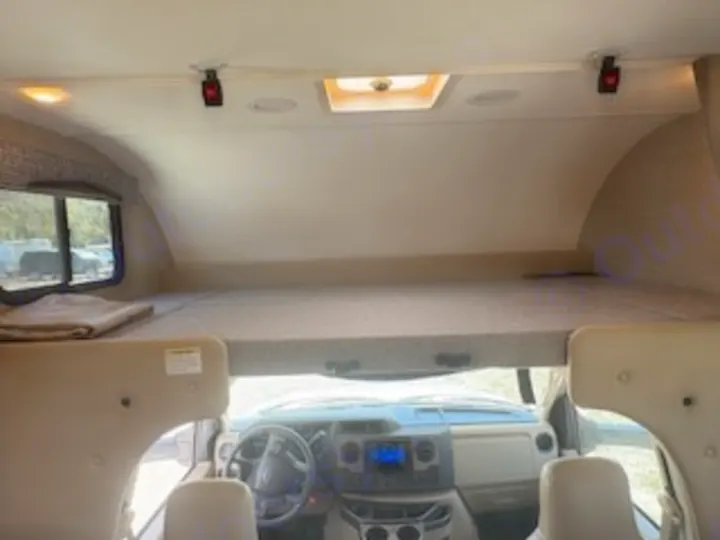 Inside this RV rental: a large overhead bunk bed above the driver's area, perfect for extra sleeping space on your trip.. Thor Chateau 2023