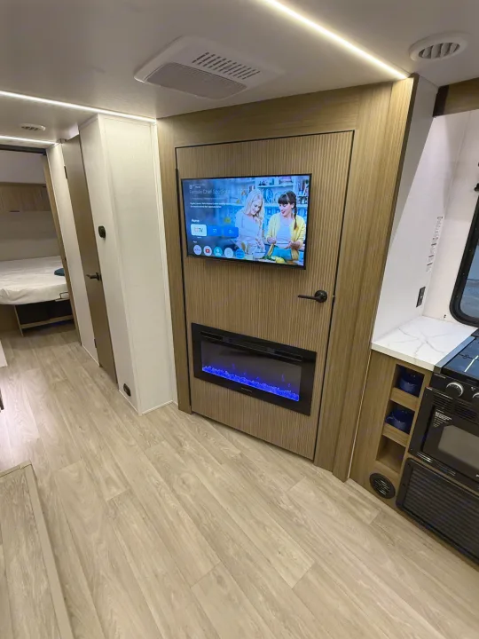 Enjoy this modern RV rental! Features a TV with streaming apps, a cozy electric fireplace with blue flames, and wood-look flooring.. Forest River Salem Cruise-Lite 2026