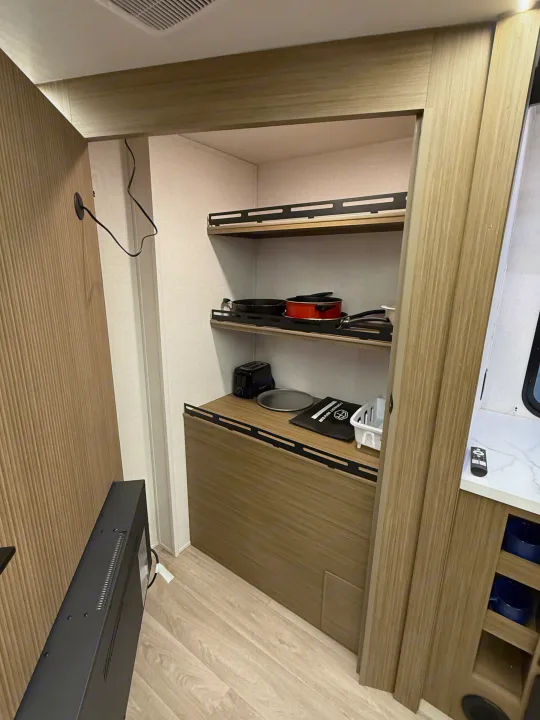 RV rental interior: a compact kitchenette with shelves, pots, a toaster, and handy built-in storage for travel.. Forest River Salem Cruise-Lite 2026