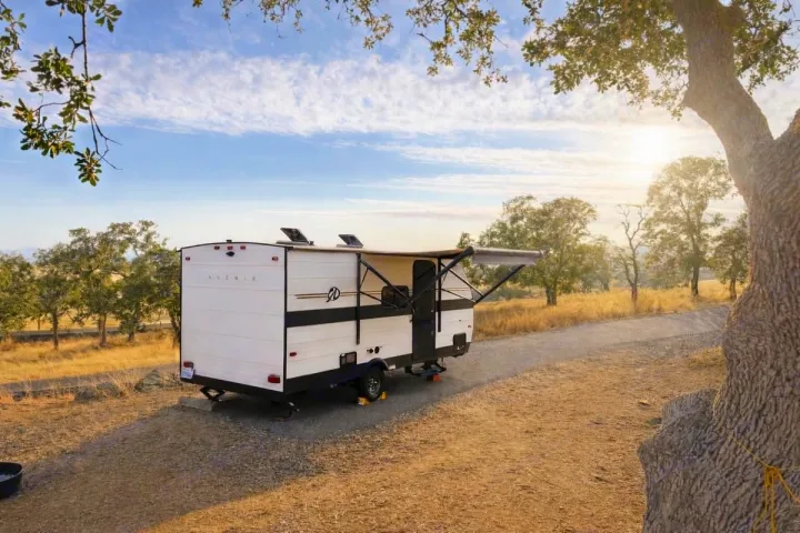 Enjoy the open road with an RV rental! This Avenir travel trailer is perfectly set up for outdoor camping in a sunny, natural landscape.. Cruiser RV Avenir 2024