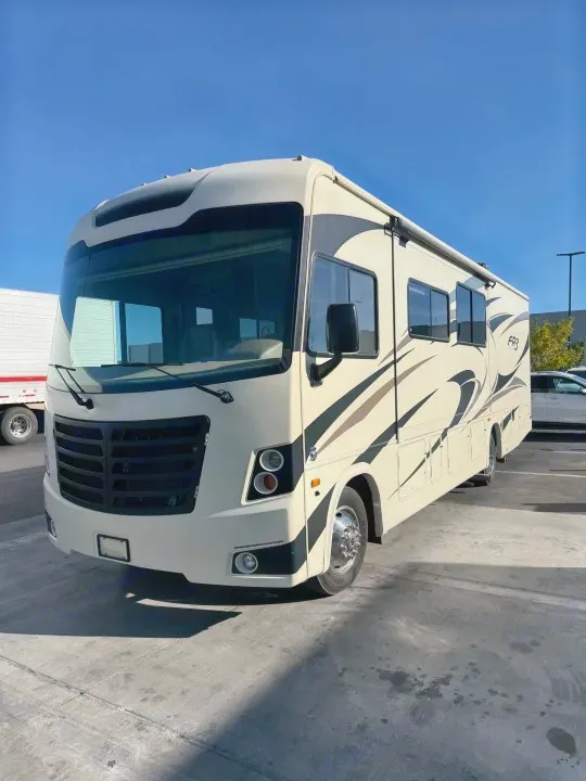 Explore with this comfortable RV rental! Cream-colored motorhome parked under a blue sky, ready for your next adventure.. FR3 FR3 Motorhome 2018