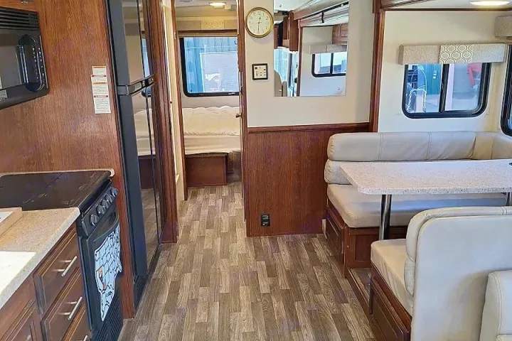 RV rental interior: kitchen with appliances, dining booth, and glimpse of the comfy sleeping area.. FR3 FR3 Motorhome 2018