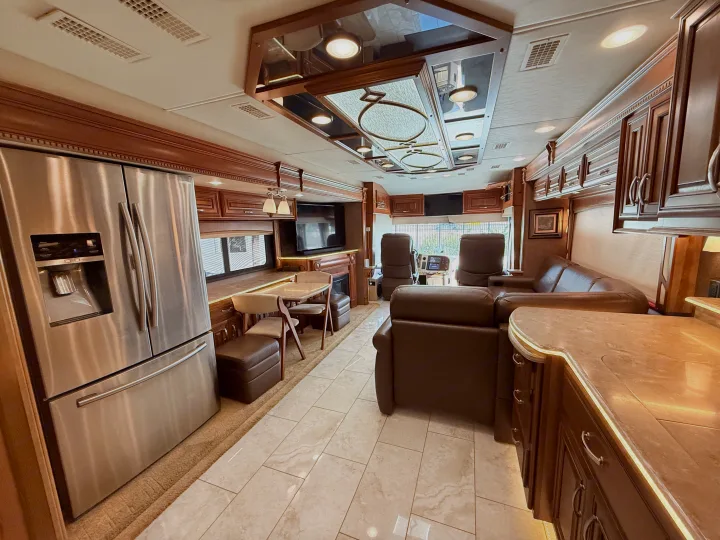 Experience a luxury rv rental! This spacious motorhome interior boasts a modern kitchen, comfy living area, and elegant wood finishes.. Entegra Coach Anthem 2019