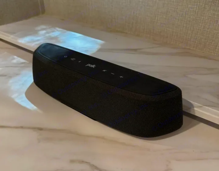 Black Polk soundbar on a marbled counter in an rv rental, offering entertainment. Ideal for travel setup.. Grand Design Imagine 2023