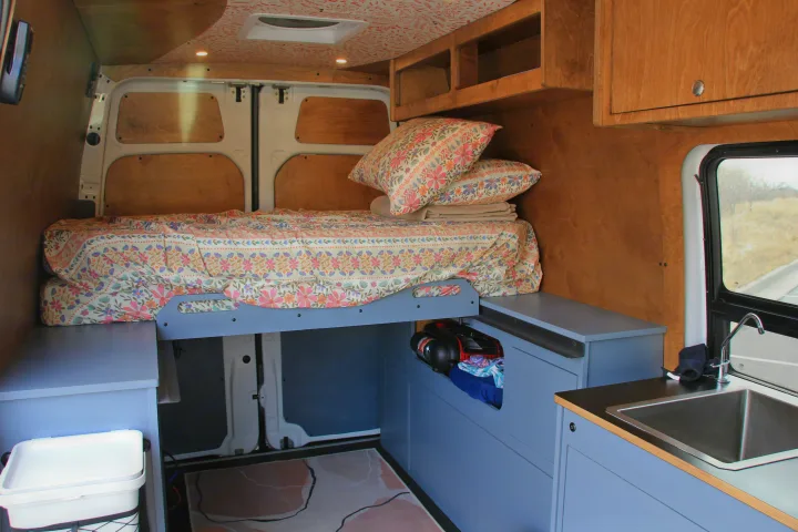 This rv rental features a well-designed camper van interior with a comfy bed, kitchen sink, and ample storage.. Mercedes-Benz Sprinter 2018