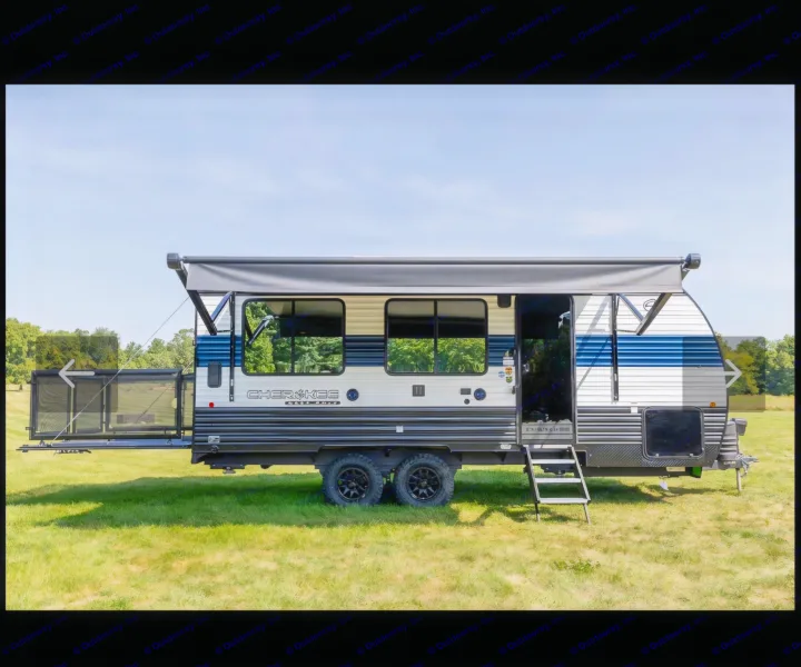 RV rental: A blue & white Cherokee travel trailer with an extended awning and rear patio deck, ready for your outdoor camping adventure.. Forest River Cherokee Grey Wolf 2023
