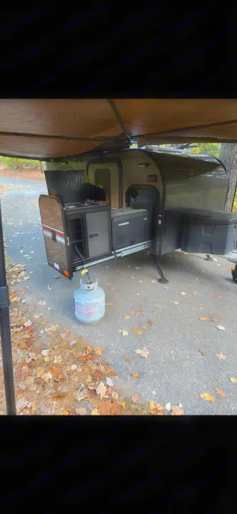 RV rental: outdoor kitchen with Dometic cooler and propane tank under an extended awning on a paved campsite.. InTech RV InTech RV Trailer 2021