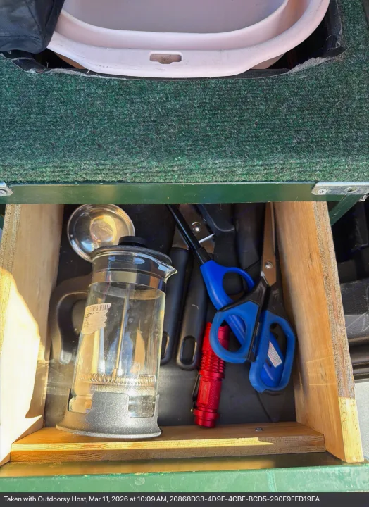 RV rental drawer: French press, lighter, flashlight, and scissors organized for your camping trip.. Ford Bronco Sport 2024