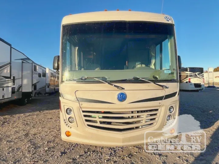 Tan Class A motorhome for rv rental, parked on a sunny lot. Ideal for your next road trip adventure or outdoor escape.. Holiday Rambler Admiral 2017