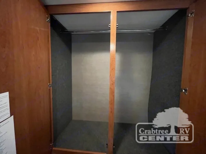 Inside an RV rental: a spacious wardrobe with a hanging rod and carpeted walls, ready for your travel essentials.. Holiday Rambler Admiral 2017