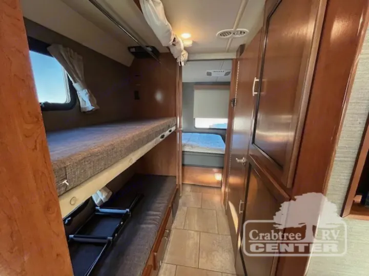 Comfortable RV rental interior with bunk beds, ideal for family adventures. Explore sleeping arrangements in this motorhome.. Holiday Rambler Admiral 2017