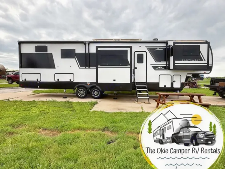 Okie Camper RV Rentals: Modern black & white fifth-wheel RV rental, perfect for your next camping adventure.. East to West Ahara 2024