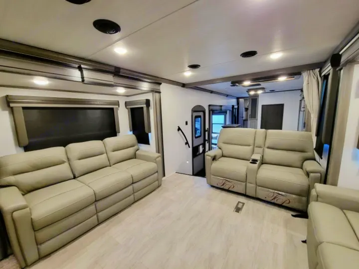 Spacious and modern RV rental living area with comfortable recliners and sofa, perfect for relaxation.. Keystone RV Montana Legacy 3761 FL 2023