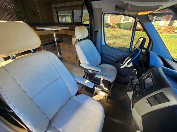 Experience comfort in this RV rental: bright driver/passenger seats, dashboard, and a rear dinette with mesh blinds.. Forest River Coachmen Prism 2020