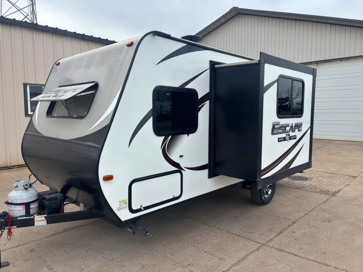 This white and black Escape travel trailer, featuring a slide-out, is ready for your next rv rental adventure.. KZ Escape 2018