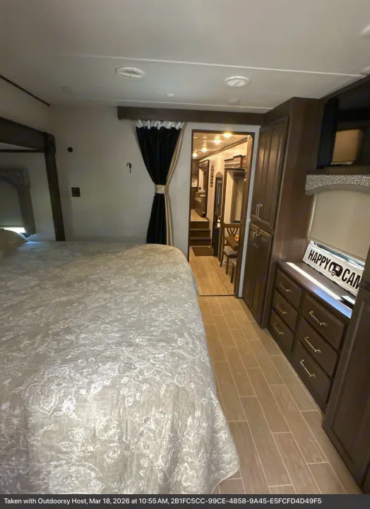 Inside this comfy RV rental: a spacious bedroom, ample storage, and a view into the rest of the camper. Happy camping awaits!. Keystone RV Alpine 2021