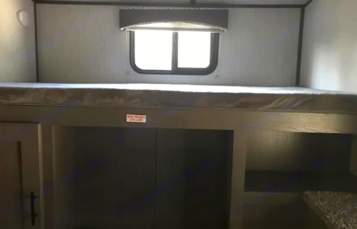 This RV rental features a cozy bunk bed with a window, built-in storage, and a clearly marked 275 lb weight limit.. Cruiser RV MPG Ultra Lite 2021