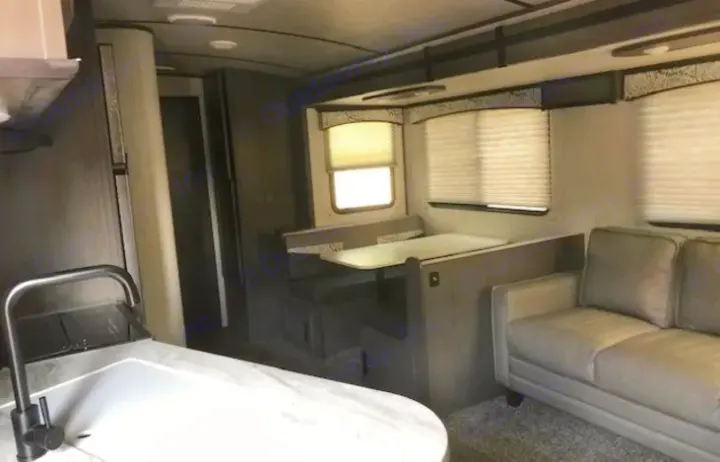 RV rental interior featuring a kitchen sink, dinette, and sofa. Bright, modern space for travel comfort.. Cruiser RV MPG Ultra Lite 2021