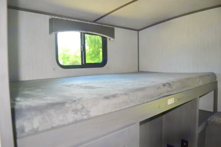Inside an RV rental: bunk bed with nature view, max 300lbs. Ideal for family travel and cozy sleeping in a motorhome.. Cruiser RV MPG Ultra Lite 2021