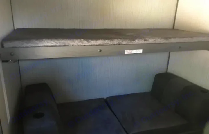 RV rental interior: A bunk bed with a 275 lbs max weight limit is shown above a lower sofa/sleeping area.. Cruiser RV Shadow Cruiser 2020
