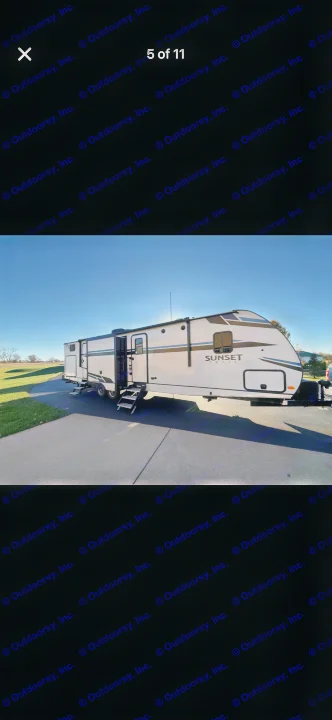 This white Sunset Trail travel trailer, perfect for an rv rental, is parked on a driveway with steps extended. Clear blue sky and green grass.. Crossroads RV Sunset Trail Super Lite 2021