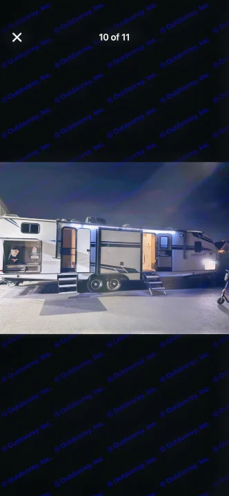 Brightly lit RV rental at night, featuring extended slide-outs and deployed steps, ready for use.. Crossroads RV Sunset Trail Super Lite 2021