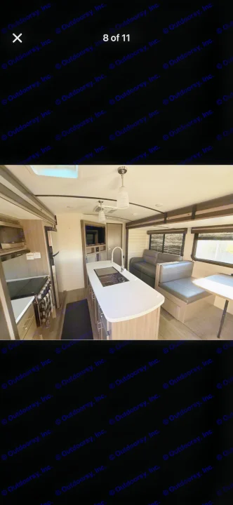 Explore this modern RV rental interior, featuring a bright kitchen island with a sink, comfortable dinette, and cozy living area.. Crossroads RV Sunset Trail Super Lite 2021