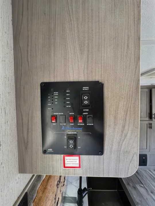This RV rental control panel shows tank/battery levels, switches for lights, awning, water heater, pump, and slide rooms.. Coleman Cch 2022