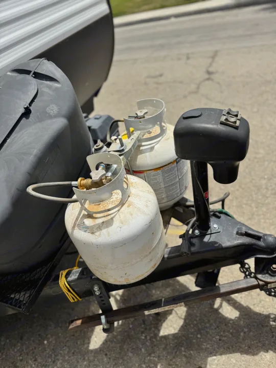 Propane tanks & hitch on an RV rental, ready to power your adventure. Essential for camping comfort.. Coleman Cch 2022