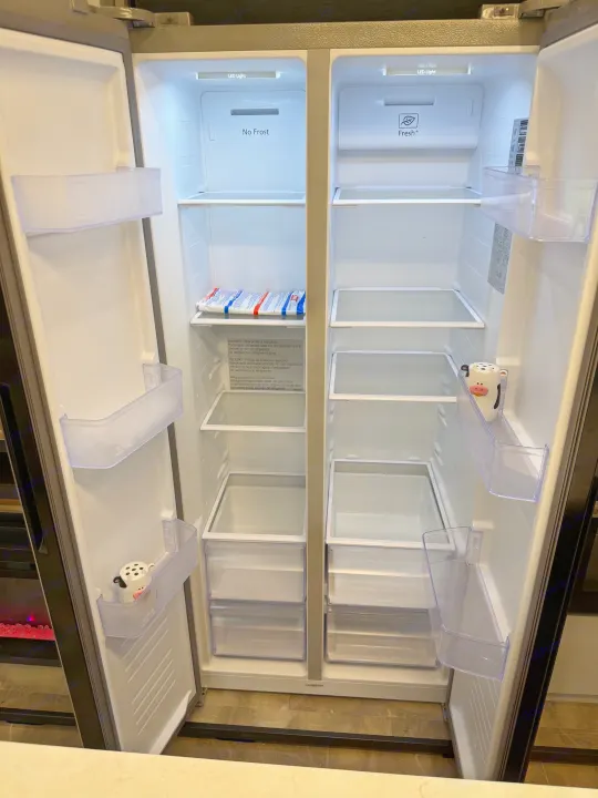 Empty side-by-side refrigerator in an RV rental, with 'No Frost' and 'Fresh+' features. All shelves and drawers are bare.. Forest River Coachman Chaparral 2025