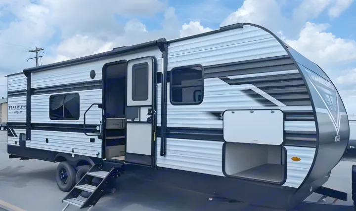 Explore the open road with this modern RV rental! A black and white travel trailer featuring an open entry door and storage.. Grand Design Transcend Xplor 2025