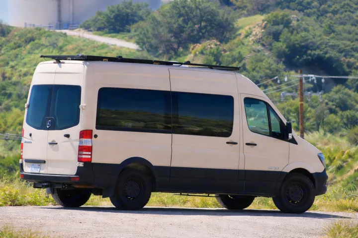 This rugged beige Mercedes-Benz Sprinter camper van, perfect for rv rental, is ready for your next outdoor adventure.. Mercedes-Benz Sprinter 2008